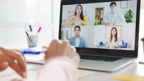 Young woman using laptop talk to colleague about plan in video call meeting while work from home.