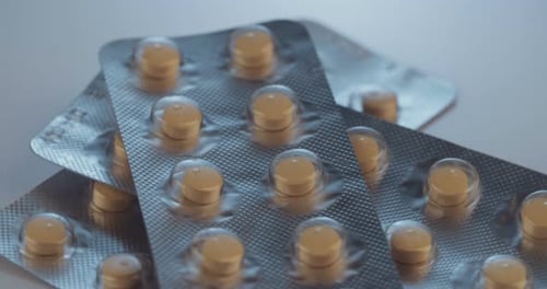 Prescription drugs - Capsules, pills, tablets on reflective background