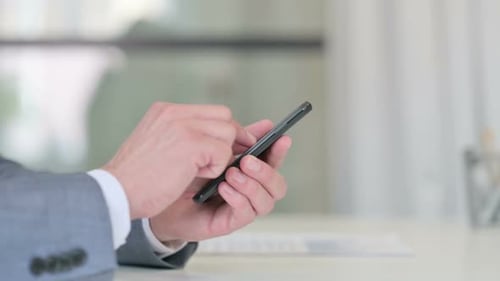 Close Up of Businessman Typing on Smartphone