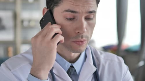 Doctor Talking on Phone Close Up Indoors