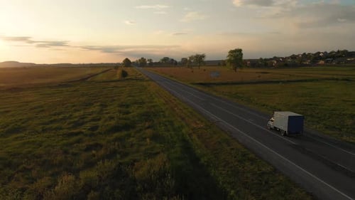 Aerial shot: vehicles, trucks and cars driving by road