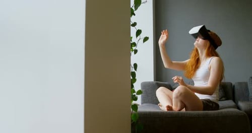 Woman Uses Virtual Reality Headset in Apartment