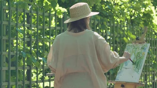 Woman Painting Outdoors on Sunny Day
