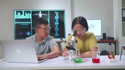 Boy And Girl Learning Science Experiment In Laboratory At Classroom. Study With Scientific Equipment