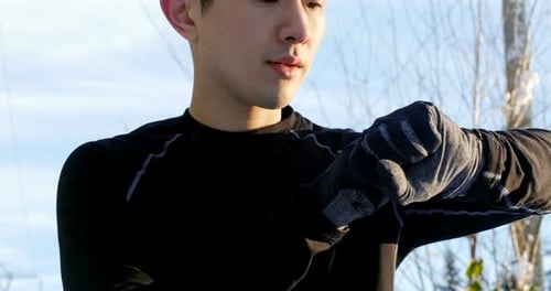 Man Checking Smartwatch Outdoors in Winter