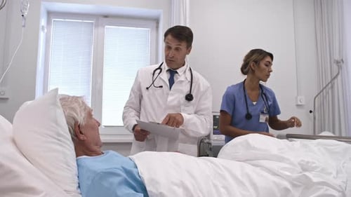 Doctor and Nurse Working with Patient in Comfortable Ward