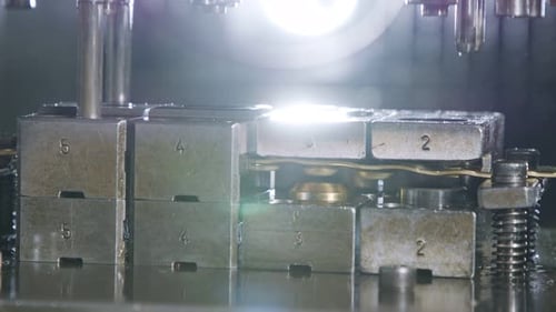 A large industrial punch press forming high precision metal parts for the automotive industry