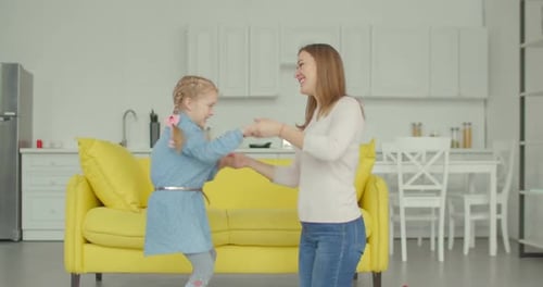 Mother and Child Dancing Together in Kitchen
