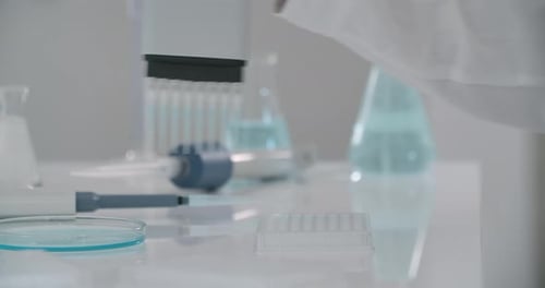 Scientist uses Multi Pipette to Conduct Experiment