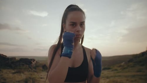 Woman Boxing Outdoors at Sunrise