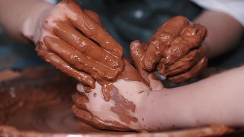 Hands Shaping Clay on a Pottery Wheel