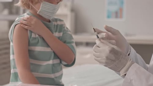 Child Receives Vaccination from Medical Professional
