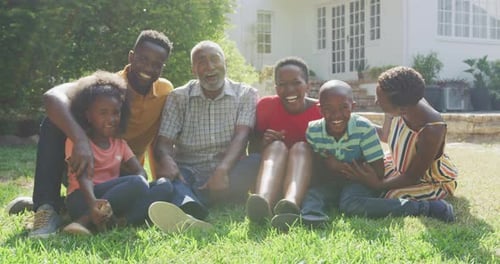 Multi-Generational Family Smiles Together in Sunny Yard
