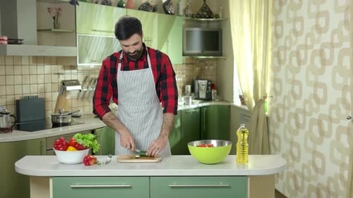Man Cuts Cucumber.