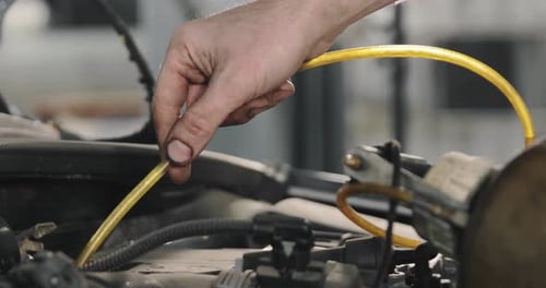 Mechanic Draining Old Brake Fluid From A System During The Service. Close Up