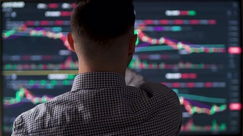 Male Trader Working with Set for Analyzing Financial Statistics and Market Data
