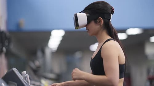 Side View Smiling Positive Sportswoman Putting on VR Headset Start Running on Treadmill