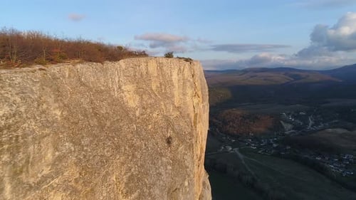 Rocky cliff on background horizon of mountain