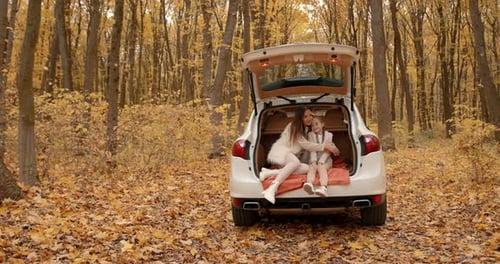 Mother and Child Hugging in the Autumn Forest