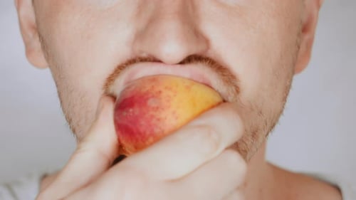 Close Up Face Fair Man Eat Apricot