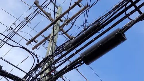 Power Pole Covered in Utility Cables