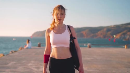 Woman Walking Toward Camera on Ocean Pier
