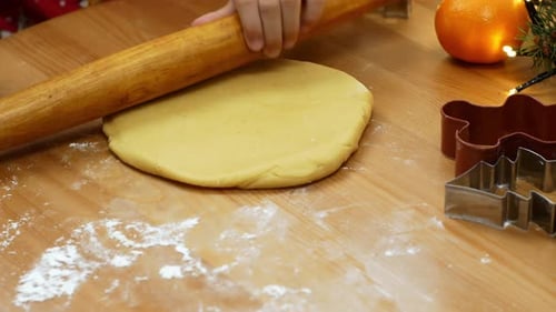 Child Rolling Cookie Dough for Christmas Baking
