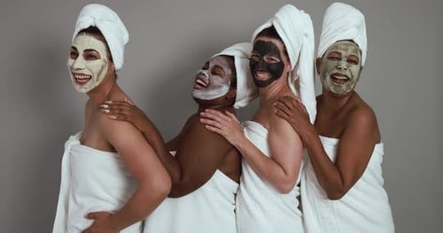 Multigenerational women having fun wearing face beauty mask - Skin care therapy and female power