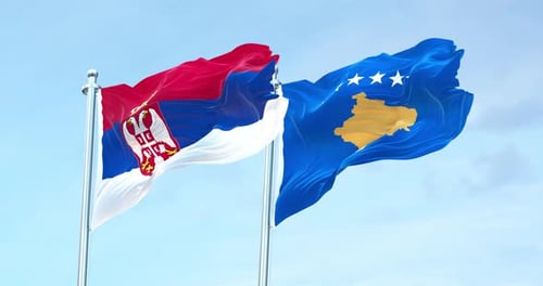 Serbia And Kosovo Flags Waving Together In Blue Sky