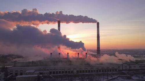 Industrial zone with large chimney, thick white smoke out of factory chimney