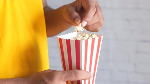 Close Up of Young Man Eating Popcorn