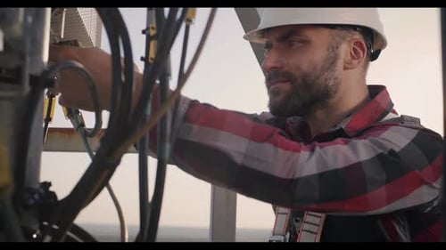 Engineer Working on a Cellular Tower