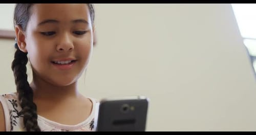 Child Looking at Cellphone Smiling Close Up