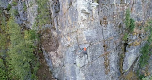 Climber climbing rocky mountain 4k