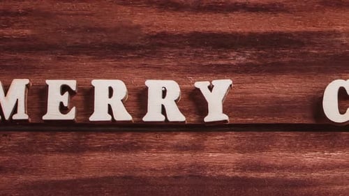 Spelling Christmas with Wooden Letters on Wood Surface