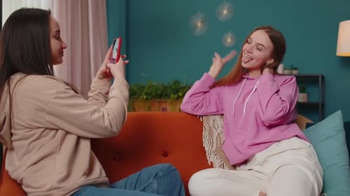 Friends Taking Photos on Couch Together Indoors