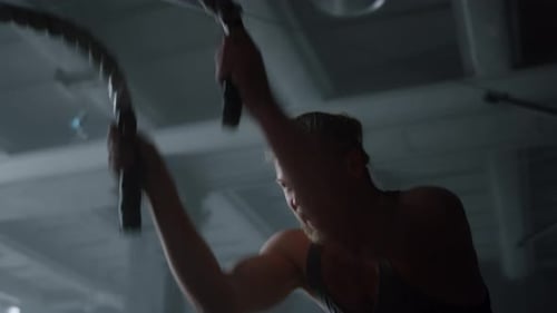 Muscular Man Intense Battle Rope Workout in Gym