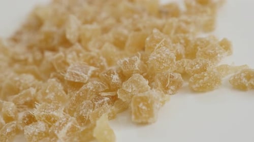 Pile of Candied ginger root on the table close-up slow tilt 4K 2160p 30fps UltraHD footage - Crysta