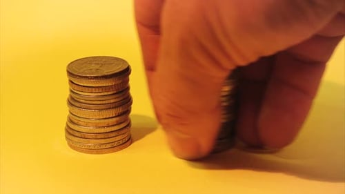 Hand Stacking Different Coins 2