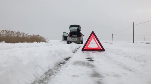 Car Trouble on a Snowy Winter Road