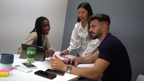 Company of diverse cheerful colleagues working in office