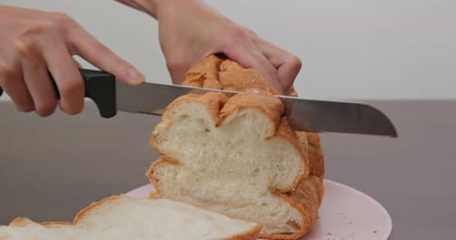 Slicing Fresh Crusty Bread With a Knife
