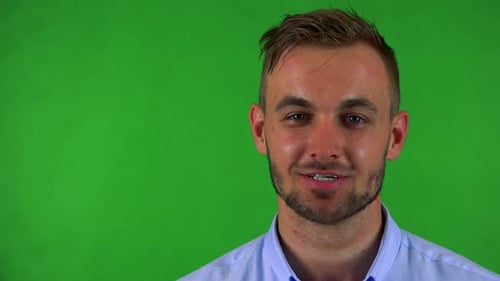 Young Handsome Business Man Smiles To Camera - Green Screen - Studio - Closeup