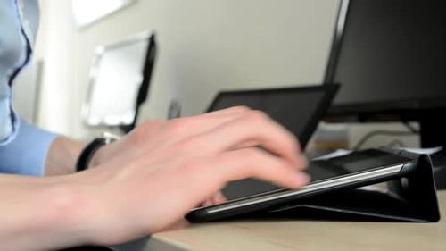 Young Handsome Man Works on Tablet in the Office - Closeup