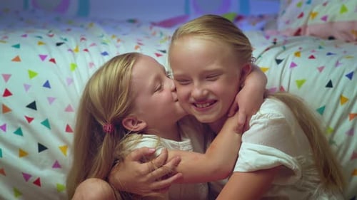 Sisters Embrace Lovingly in Bedroom