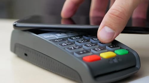 Mobile Phone Payment at POS Terminal Close Up