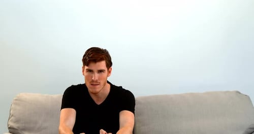 Young Man Playing Video Games on Couch