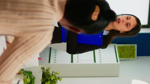 Businesswoman Discussing Project Progress in Modern Office