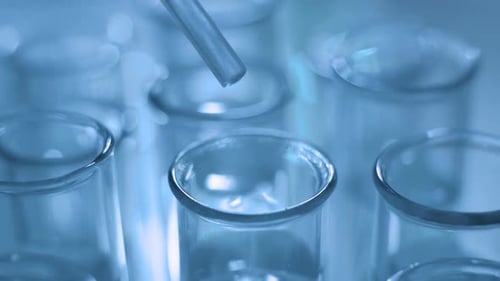 Close Up of Pipette with Liquid Blue Water Drop Intro Glass Test Tube in Laboratory