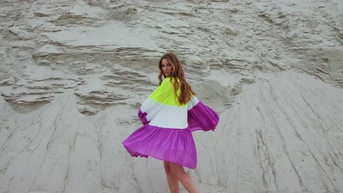 Woman in Colorful Dress Posing in Desert